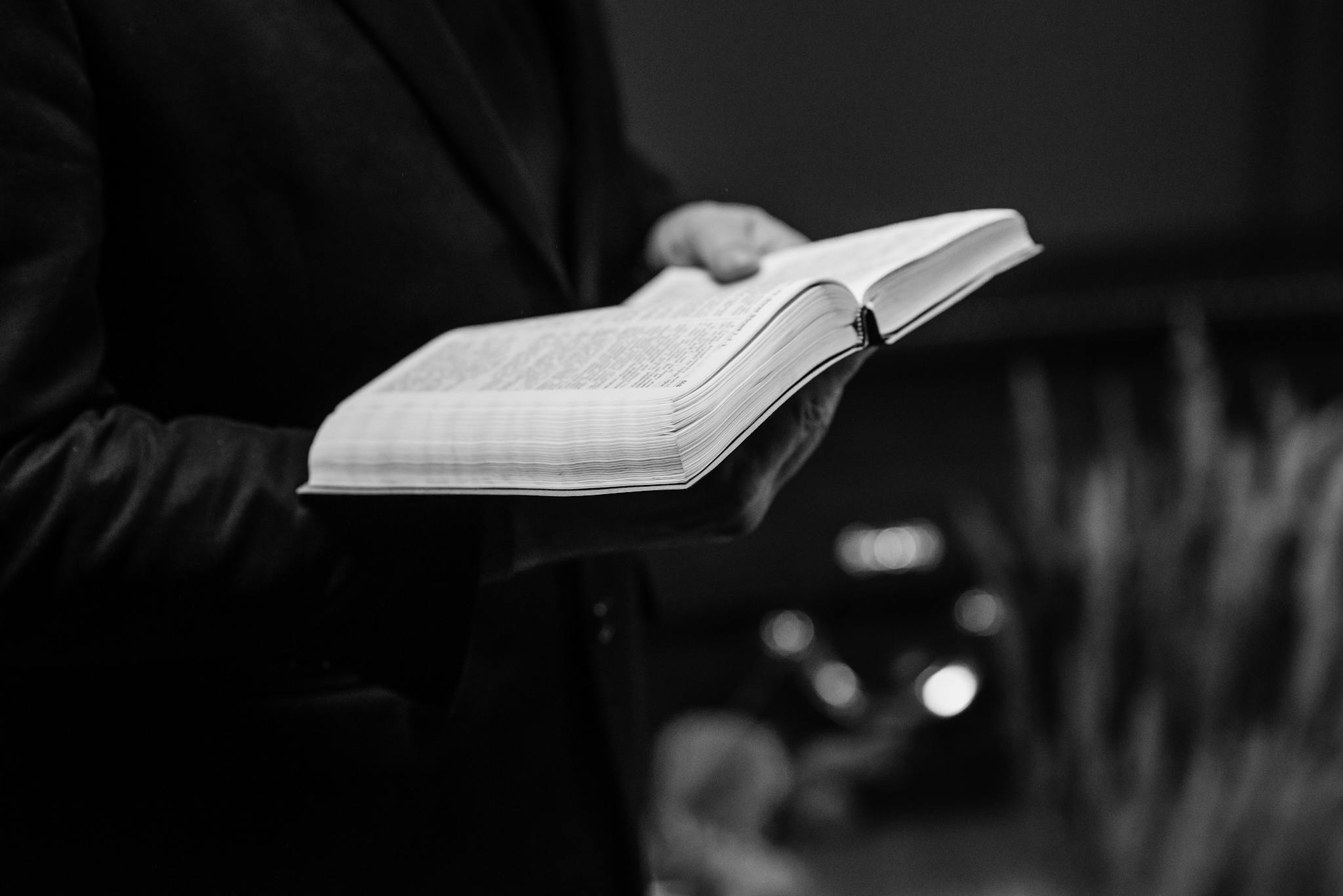 Expository preacher holding a bible while preaching an expository sermon